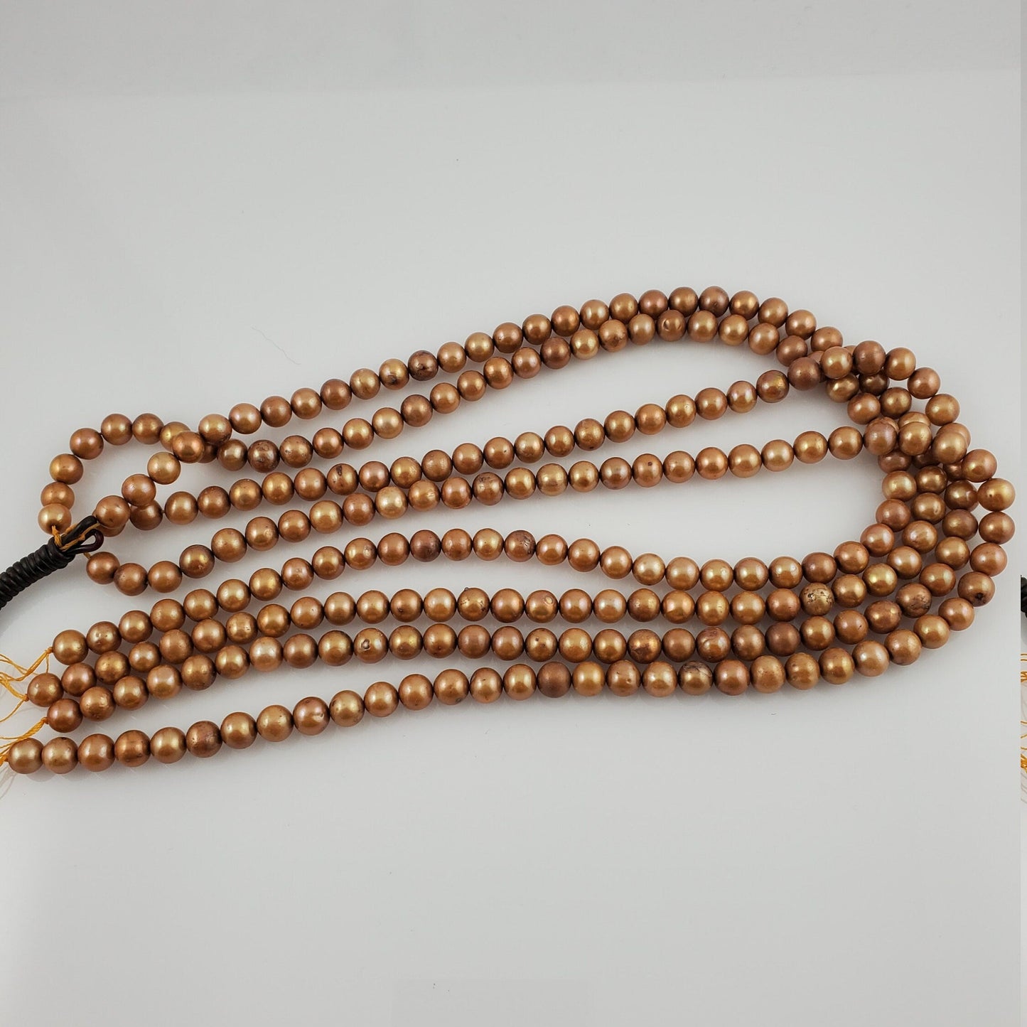 Brown beaded necklace on a light gray background