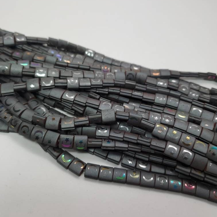 String of black square beads on a white background