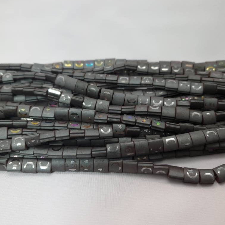 String of dark gray beads on a light gray background